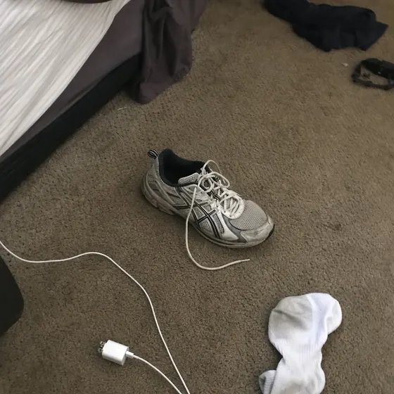 The original image uploaded for the sneaker on a bedroom floor